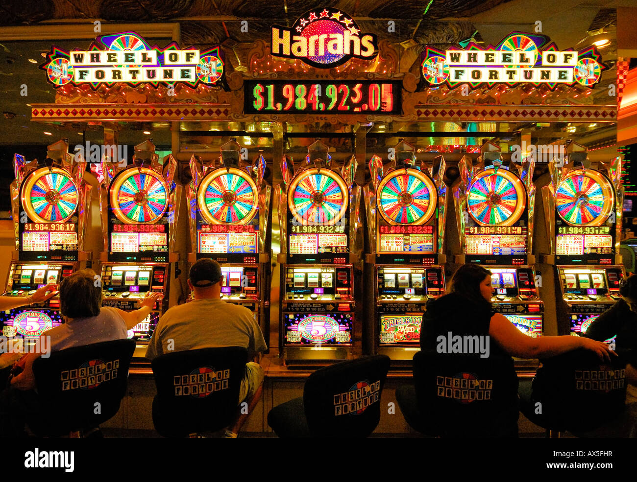 Gamblers sitting in front of slot machines in Harrah's Casino on the ...